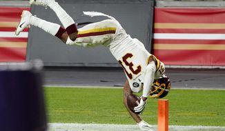 Washington Football Team strong safety Kamren Curl (31) dives into the end zone for a touchdown after an interception against the San Francisco 49ers during the second half of an NFL football game, Sunday, Dec. 13, 2020, in Glendale, Ariz. (AP Photo/Rick Scuteri)