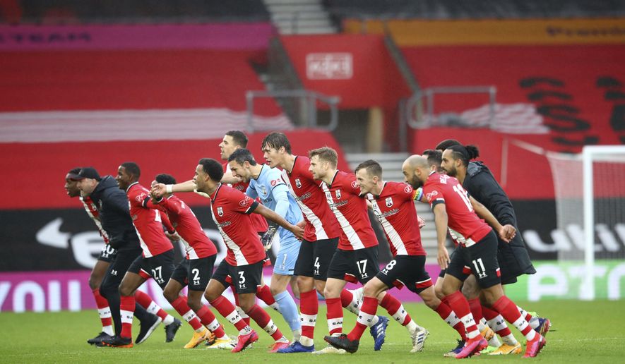 Southampton&#39;s players celebrate at the end the English Premier League soccer match between Southampton and Sheffield United, at St. Mary&#39;s stadium in Southampton, England, Saturday, Dec. 13, 2020. Southampton won 3-0. (Michael Steele/Pool via AP)