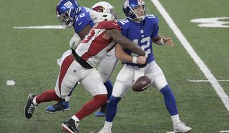 Arizona Cardinals&#39; Haason Reddick, left, knocks the ball out of New York Giants quarterback Colt McCoy&#39;s hands during the second half of an NFL football game, Sunday, Dec. 13, 2020, in East Rutherford, N.J. (AP Photo/Bill Kostroun)