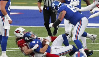 New York Giants quarterback Daniel Jones, bottom center, is sacked during the second half of an NFL football game against the Arizona Cardinals, Sunday, Dec. 13, 2020, in East Rutherford, N.J. (AP Photo/Noah K. Murray)