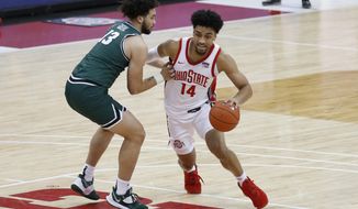 Ohio State&#x27;s Justice Sueing, right, drives to the basket against Cleveland State&#x27;s Chris Greene during the second half of an NCAA college basketball game Sunday, Dec. 13, 2020, in Columbus, Ohio.  (AP Photo/Jay LaPrete)
