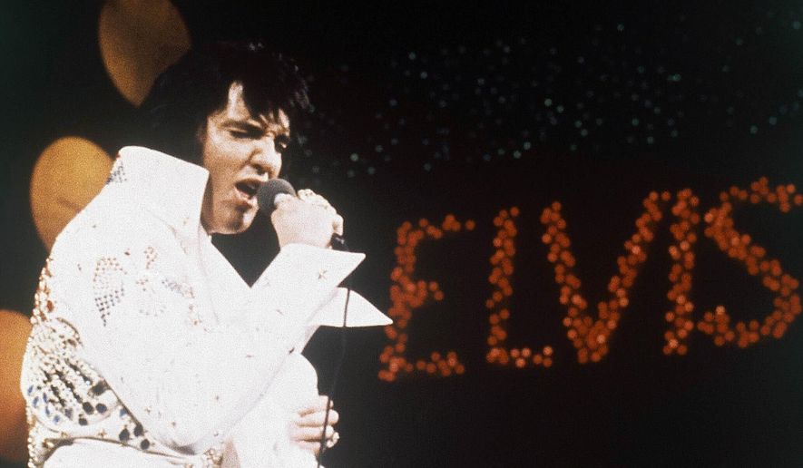 This 1972 file photo shows Elvis Presley, the King of Rock "n" Roll, during a performance. At one of three concerts at the Monroe Civic Center in 1974, Elvis Presley gave one of his necklaces to a local 5-year-old. A documentary from Elvis historian and fan Bud Glass traces how the King of Rock ’N Roll traces the history of the piece. (AP Photo/File)