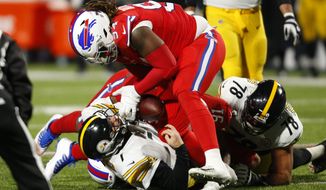 Pittsburgh Steelers quarterback Ben Roethlisberger (7) fumbles the ball as he is sacked by Buffalo Bills defensive tackle Ed Oliver (91) and Vernon Butler (94) during the second half of an NFL football game in Orchard Park, N.Y., Sunday, Dec. 13, 2020. The Bills recovered the ball. (AP Photo/Jeffrey T. Barnes )