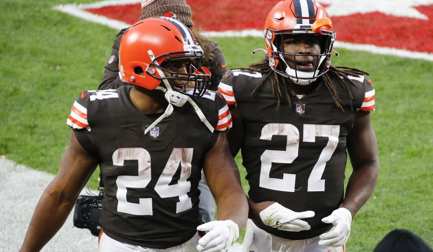 File-This Nov. 15, 2020, file photo shows Cleveland Browns running backs Nick Chubb (24) and Kareem Hunt (27) walking off the field after the Browns defeated the Houston Texans in Cleveland. One is quiet, super steady, and a rising NFL star. Cleveland&#39;s other running back is outgoing, flashy, and has his career back on track after a major detour. Chubb and Hunt couldn&#39;t be any different. (AP Photo/Ron Schwane, File)