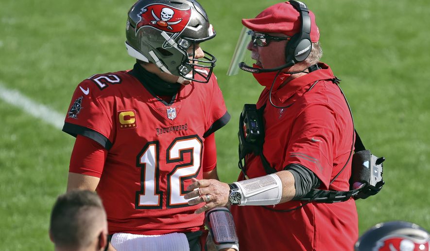 Tampa Bay Buccaneers head coach Bruce Arians congratulates quarterback Tom Brady (12) after a touchdown pass to wide receiver Scott Miller (10) during the first half of an NFL football game against the Minnesota Vikings Sunday, Dec. 13, 2020, in Tampa, Fla. (AP Photo/Mark LoMoglio)