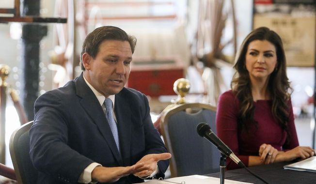 Florida Gov. Ron DeSantis answers questions as his wife Casey DeSantis listens following a roundtable discussion regarding mental health at the Tampa Firefighter Museum, Friday, Dec. 11, 2020, in Tampa, Fla. (Ivy Ceballo/Tampa Bay Times via AP) ** FILE **