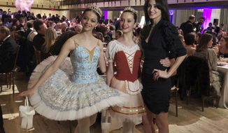 FILE - In this image taken from video, choreographer Melanie Hamrick poses for a photo with young dancers at the gala of Youth America Grand Prix, the world&#x27;s largest ballet scholarship competition, on April 18, 2019, after the U.S. premiere of her new ballet, &amp;quot;Porte Rouge&amp;quot; (Red Door). Hamrick&#x27;s Live Arts Global company is producing “A Night at the Ballet,” a free streaming event that premieres this week. The event will treat ballet-starved fans to dancers from America’s top companies performing excerpts of classical ballets like “Romeo and Juliet, “The Nutcracker” and “Don Quixote.”  (AP Photo/Aron Ranen, File)