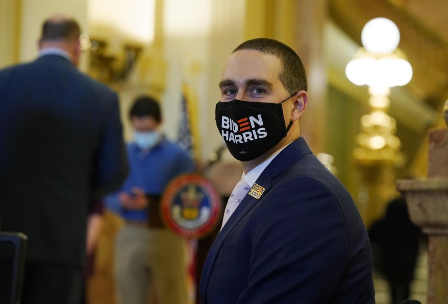 Alan Kennedy, of Denver, one of Colorado's nine Democratic presidential electors, wears a face mask as he waits to cast his ballot for Joe Biden at the State Capitol on Monday, Dec. 14, 2020, in downtown Denver. (AP Photo/David Zalubowski, Pool)