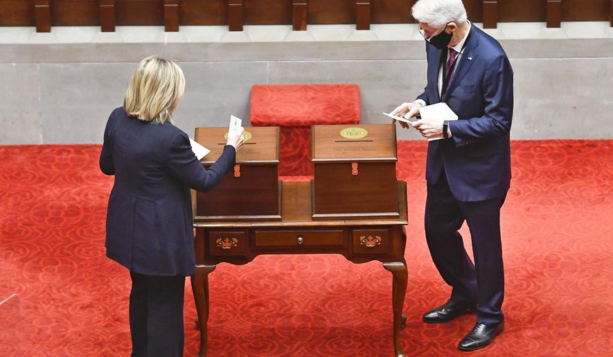 New York Electoral College members, Former Sec. of State Hillary Clinton, left, and Former President Bill Clinton, vote for President and Vice President in the Assembly Chamber at the state Capitol in Albany, N.Y., Monday, Dec. 14, 2020. (AP Photo/Hans Pennink, Pool)