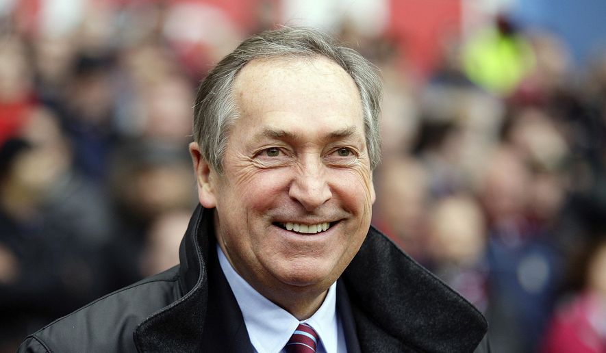FILE - In this Sunday, Oct. 31, 2010 file photo, Aston Villa Gerard Houllier looks on before his team&#39;s English Premier League soccer against Birmingham City at Villa Park stadium, Birmingham, England. Gerard Houllier, a Frenchman who won three titles in one season as coach of English club Liverpool, has died. He was 73. Liverpool announced the death on Twitter on Monday Dec. 14, 2020. French sports daily L’Equipe said Houllier died following heart surgery in France. (AP Photo/Simon Dawson, File)