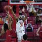 Maryland forward Galin Smith (30) blocks a shot by Rutgers guard Ron Harper Jr. during the first half of an NCAA college basketball game, Monday, Dec. 14, 2020, in College Park, Md. (AP Photo/Julio Cortez)