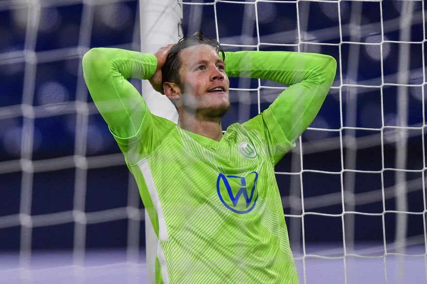 FILE - In this Saturday, Nov. 21, 2020 file photo, Wolfsburg's Wout Weghorst reacts during the German Bundesliga soccer match between VfL Wolfsburg and FC Schalke 04 at the Veltins-Arena in Gelsenkirchen, Germany. Dutch striker Wout Weghorst has apologized for appearing to make light of the coronavirus in a social media post on Monday, Dec. 14, 2020. Weghorst was trending on Twitter in Germany due to his Instagram story in which he appeared to endorse a message saying, “Imagine a vaccine so safe you have to be threaten to take it -- for a disease so deadly you have to be tested to know you have it.” (AP Photo/Martin Meissner, Pool, File)