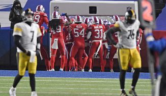 Pittsburgh Steelers quarterback Ben Roethlisberger (7) and Chukwuma Okorafor (76) walk off the field as the Buffalo Bills defense celebrates a 51-yard interception returned for a touchdown during the first half of an NFL football game in Orchard Park, N.Y., Sunday, Dec. 13, 2020. (AP Photo/Adrian Kraus)