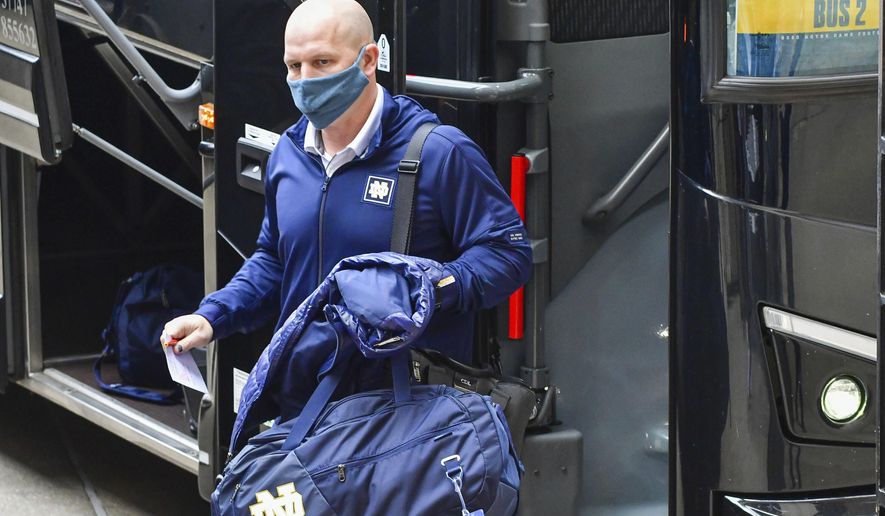 FILE - Notre Dame defensive coordinator Clark Lea steps off the team bus before an NCAA college football game in South Bend, Ind., Saturday, Dec. 5, 2020. Vanderbilt is negotiating a deal with Notre Dame defensive coordinator Clark Lea to make the former Commodores football player its new head coach. Two people with knowledge of the situation told The Associated Press details of a contract were still being worked out but Lea was the school's top choice.(Matt Cashore/Pool Photo via AP, File)