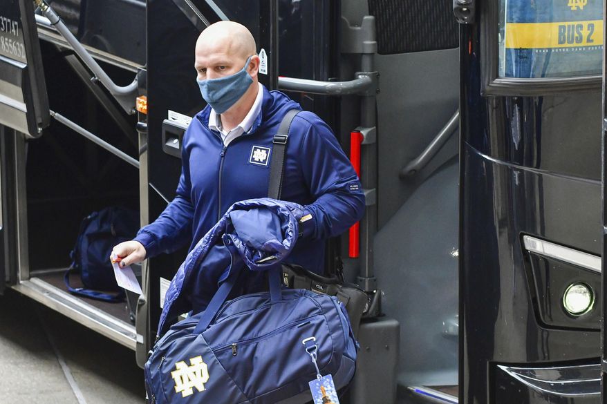 FILE - Notre Dame defensive coordinator Clark Lea steps off the team bus before an NCAA college football game in South Bend, Ind., Saturday, Dec. 5, 2020. Vanderbilt is negotiating a deal with Notre Dame defensive coordinator Clark Lea to make the former Commodores football player its new head coach. Two people with knowledge of the situation told The Associated Press details of a contract were still being worked out but Lea was the school's top choice.(Matt Cashore/Pool Photo via AP, File)