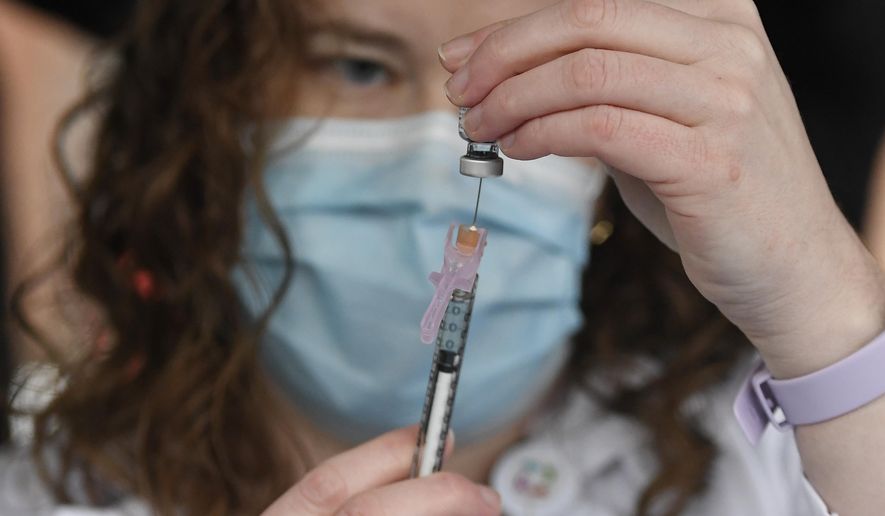 System Pharmacy Clinical Manager at Hartford HealthCare Colleen Teevan prepares the Pfizer-BioNTech vaccine for COVID-19 to give to a front line worker outside of Hartford Hospital, Monday, Dec. 14, 2020, in Hartford, Conn. (AP Photo/Jessica Hill)