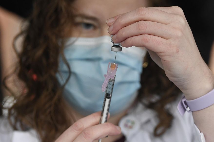 System Pharmacy Clinical Manager at Hartford HealthCare Colleen Teevan prepares the Pfizer-BioNTech vaccine for COVID-19 to give to a front line worker outside of Hartford Hospital, Monday, Dec. 14, 2020, in Hartford, Conn. (AP Photo/Jessica Hill)