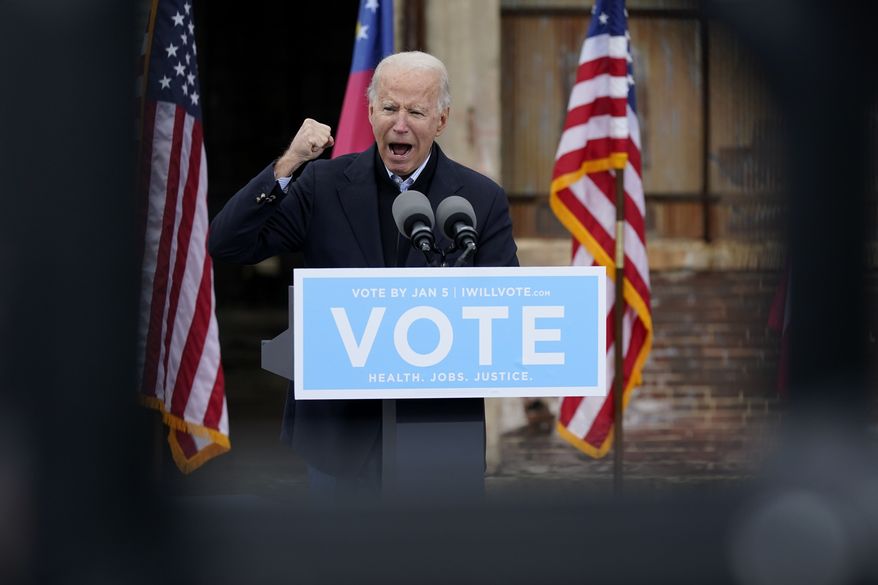 President-elect Joe Biden speaks at a drive-in rally for Georgia Democratic candidates for U.S. Senate Raphael Warnock and Jon Ossoff, Tuesday, Dec. 15, 2020, in Atlanta. (AP Photo/Patrick Semansky)