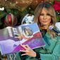 First lady Melania Trump reads a Christmas book titled, &quot;Oliver the Ornament Meets Marley and Joan and Abbey,&quot; at Children&#x27;s National Hospital, Tuesday, Dec. 15, 2020, in Washington. Due to pandemic concerns there were two children in the room and the reading was broadcast to children in the rest of the hospital. (AP Photo/Jacquelyn Martin)