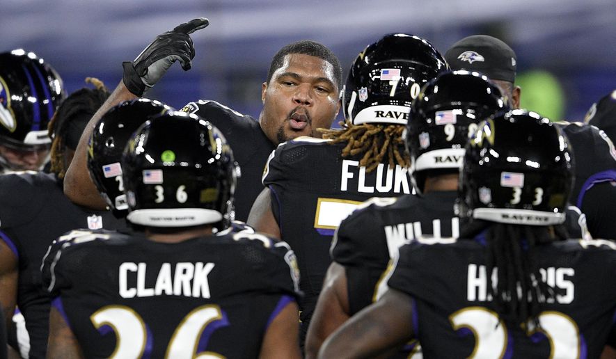 Baltimore Ravens defensive end Calais Campbell, center, leads a huddle with teammates after working out prior to an NFL football game against the Dallas Cowboys, Tuesday, Dec. 8, 2020, in Baltimore. (AP Photo/Nick Wass)