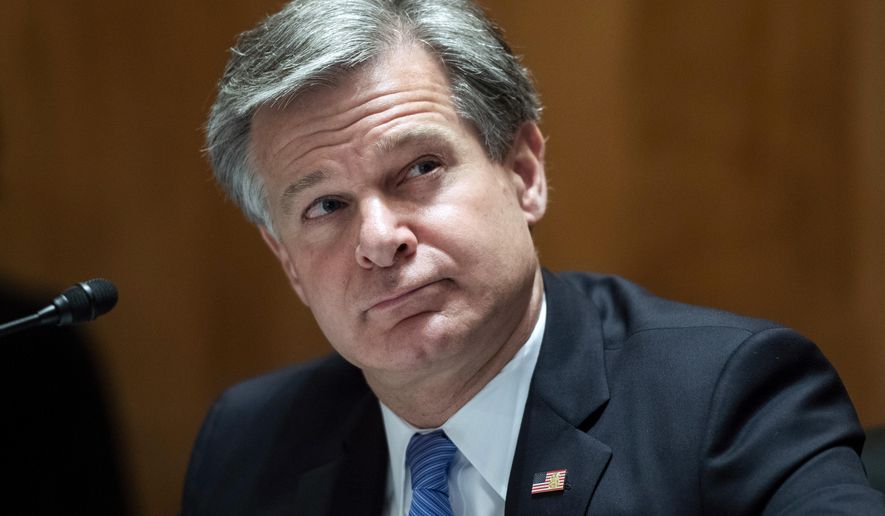 In this Sept. 24, 2020, file photo, FBI Director Christopher A. Wray, testifies during a Senate Homeland Security and Governmental Affairs Committee hearing on &amp;quot;Threats to the Homeland&amp;quot; on Capitol Hill in Washington. (Tom Williams/Pool via AP, File)
