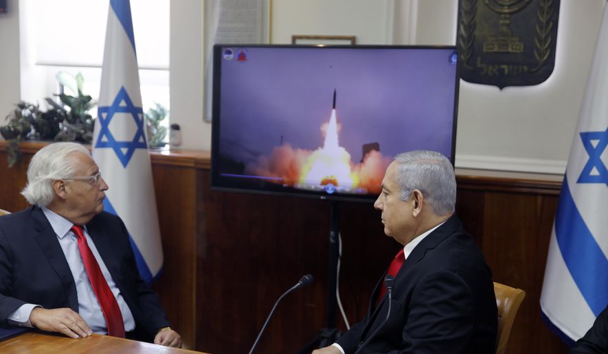 In this July 28 2019, file photo, Israeli Prime Minister Benjamin Netanyahu, right, and U.S. Ambassador to Israel David Friedman watch a video that shows the launch of the Arrow 3 hypersonic anti-ballistic missile during a Cabinet meeting in Jerusalem. Israel’s Defense Ministry said, Tuesday, Dec. 15, 2020, that it has successfully conducted a series of live fire drills to test its three missile defense systems. It has developed and tested the Arrow 3, David’s Sling and Iron Dome in conjunction with the United States. (Menahem Kahana/Pool  via AP, File)