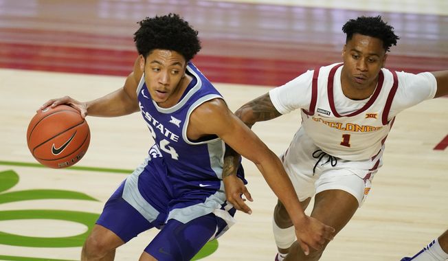 Kansas State guard Nijel Pack drives around Iowa State guard Tyler Harris, right, during the first half of an NCAA college basketball game, Tuesday, Dec. 15, 2020, in Ames, Iowa. (AP Photo/Charlie Neibergall)