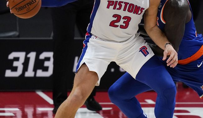 Detroit Pistons forward Blake Griffin (23) is defended by New York Knicks forward Julius Randle during the first half of a preseason NBA basketball game Friday, Dec. 11, 2020, in Detroit. (AP Photo/Carlos Osorio)