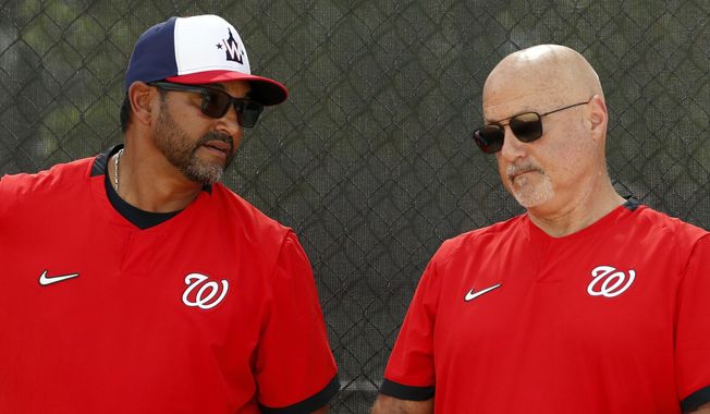 In this Feb. 17, 2020, file photo, Washington Nationals manager Dave Martinez, left, talks with general manager Mike Rizzo during spring training baseball practice in West Palm Beach, Fla. Nationals general manager Mike Rizzo says his top offseason priority is adding a middle-of-the-order hitter.  (AP Photo/Jeff Roberson, File). **FILE**