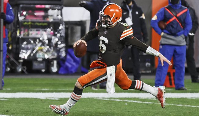Cleveland Browns quarterback Baker Mayfield rushes for a 5-yard touchdown during the second half of an NFL football game against the Baltimore Ravens, Monday, Dec. 14, 2020, in Cleveland. (AP Photo/Ron Schwane)