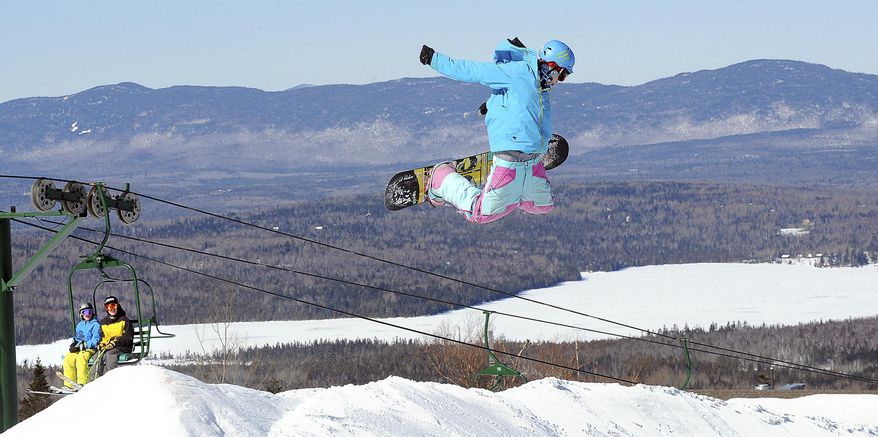 FILE - In this Feb. 23, 2011 file photo, Colby Wheaton, of Phillips, Maine flies over a jump at Saddleback Mountain in Rangeley, Maine. Saddleback Mountain is reopening in the middle of a pandemic, but General Manager Andy Shepard believes people are hankering to get outside. The mountain is reopening after a five-year hiatus with revamped lodge, a new chairlift and changes in the lodge aimed at making skiing safer. (Russ Dillingham/Sun Journal via AP)
