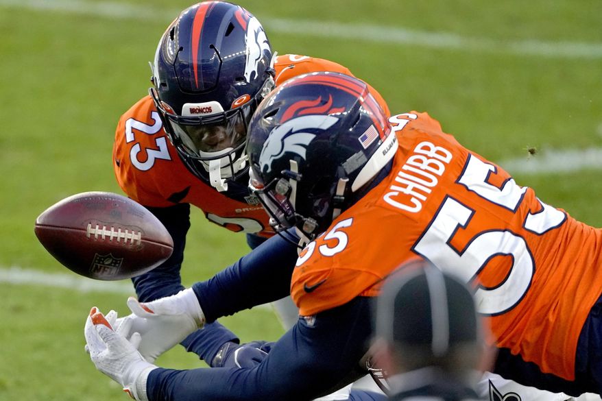 Denver Broncos outside linebacker Bradley Chubb (55) and cornerback Michael Ojemudia (23) can't hold on to an incomplete pass against the New Orleans Saints during the second half of an NFL football game, Sunday, Nov. 29, 2020, in Denver. (AP Photo/Jack Dempsey)