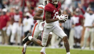 FILE - Alabama wide receiver DeVonta Smith (6) runs with a reception for a touchdown against Auburn during an NCAA college football game in Tuscaloosa, Ala, in this Saturday, Nov. 28, 2020, file photo. The Southeastern Conference championship game features two of the nation’s top playmakers, and neither is a quarterback.Alabama receiver DeVonta Smith and Florida tight end Kyle Pitts are the real stars of the league’s most potent offenses.(Mickey Welsh/The Montgomery Advertiser via AP, File)