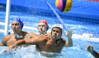 Ben Hallock, right, of the U.S. and Dmitrii Kholod of Russia fight for the ball during the men&#39;s water polo Group D third round match of the 17th FINA Swimming World Championships in Hajos Alfred National Swimming Pool in Budapest, Hungary, in this Friday, July 21, 2017, file photo. Hallock, 23, is among 18 U.S. men’s water polo players who joined professional teams in Europe after COVID-19 hampered their training in California. (Szilard Koszticsak/MTI via AP, File)