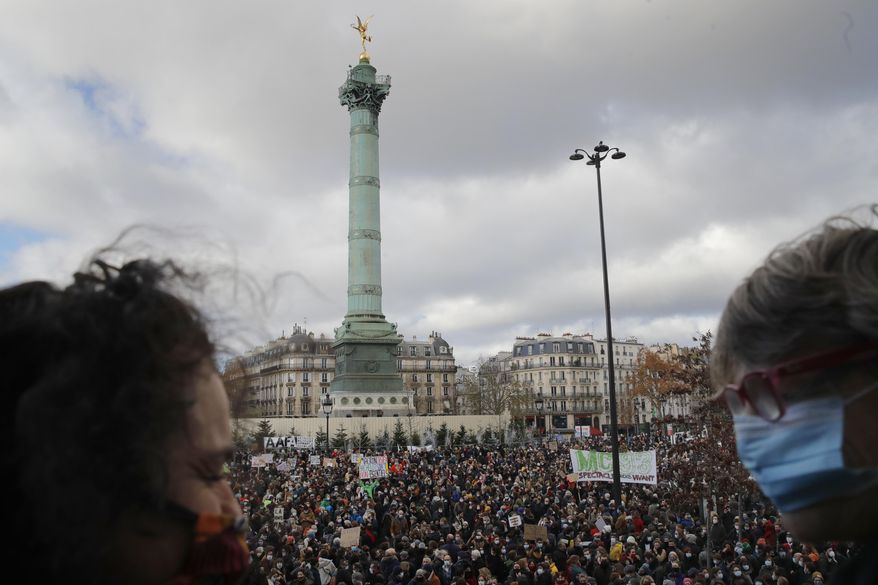 Workers from the cultural sector gather during a protest, in Paris, Tuesday, Dec.15, 2020. Representatives of the performing arts sector protested against the ongoing closure of theaters and cinemas in the country as France on Tuesday is lifting a lockdown imposed on 30 October, but strict measures are still in place as infections are still high. (AP Photo/Christophe Ena)