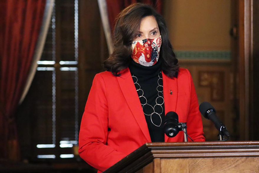In a photo provided by the Michigan Office of the Governor, Gov. Gretchen Whitmer addresses the state during a speech in Lansing, Mich., Tuesday, Dec. 15, 2020. The governors's administration reported progress Tuesday in the fight against the coronavirus, saying new cases continue to decline and Michigan has seen no spike related to Thanksgiving travel. Officials warned, though, that the case rate remains high. (Michigan Office of the Governor via AP)