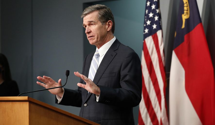 North Carolina Gov. Roy Cooper speaks during a briefing at the Emergency Operations Center in Raleigh, N.C., Tuesday, Dec. 15, 2020. (Ethan Hyman/The News & Observer via AP)