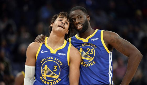 In this Nov. 19, 2019, file photo, Golden State Warriors guard Jordan Poole (3) and forward Draymond Green (23) talk during a break in the first half of an NBA basketball game against the Memphis Grizzlies in Memphis, Tenn. (AP Photo/Brandon Dill, File) **FILE**