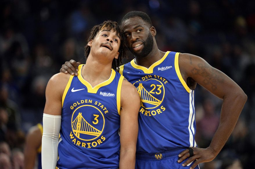 In this Nov. 19, 2019, file photo, Golden State Warriors guard Jordan Poole (3) and forward Draymond Green (23) talk during a break in the first half of an NBA basketball game against the Memphis Grizzlies in Memphis, Tenn. (AP Photo/Brandon Dill, File) **FILE**