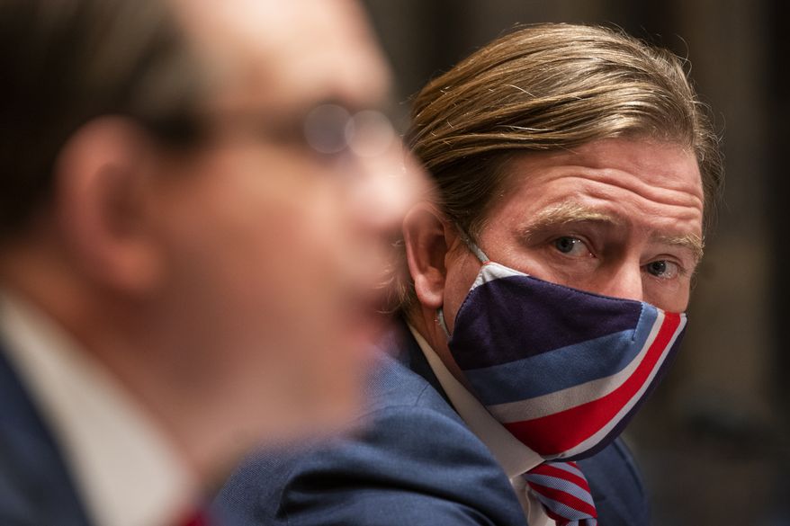 Christopher Krebs, former director of the Cybersecurity and Infrastructure Security Agency, listens as Attorney Jesse Binnall, an attorney for the Trump campaign, left, speaks during a Senate Homeland Security & Governmental Affairs Committee hearing to discuss election security and the 2020 election process on Wednesday, Dec. 16, 2020, on Capitol Hill in Washington. (Jim Lo Scalzo/Pool via AP)