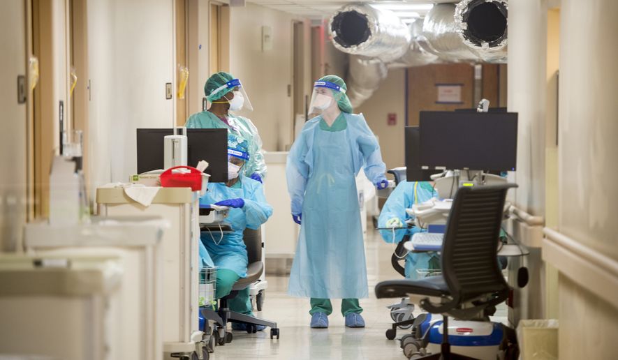 Medical personnel work inside the COVID-19 unit at University Hospital in Augusta, Ga., Wednesday, Dec. 16, 2020. COVID-19 cases nationwide have been increasing in recent weeks. (Michael Holahan/The Augusta Chronicle via AP)