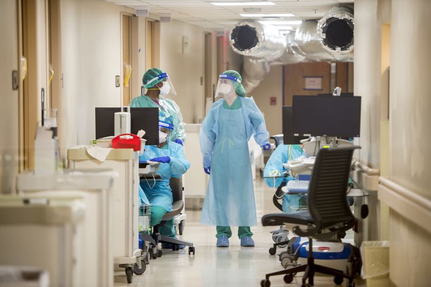 Medical personnel work inside the COVID-19 unit at University Hospital in Augusta, Ga., Wednesday, Dec. 16, 2020. COVID-19 cases nationwide have been increasing in recent weeks. (Michael Holahan/The Augusta Chronicle via AP)