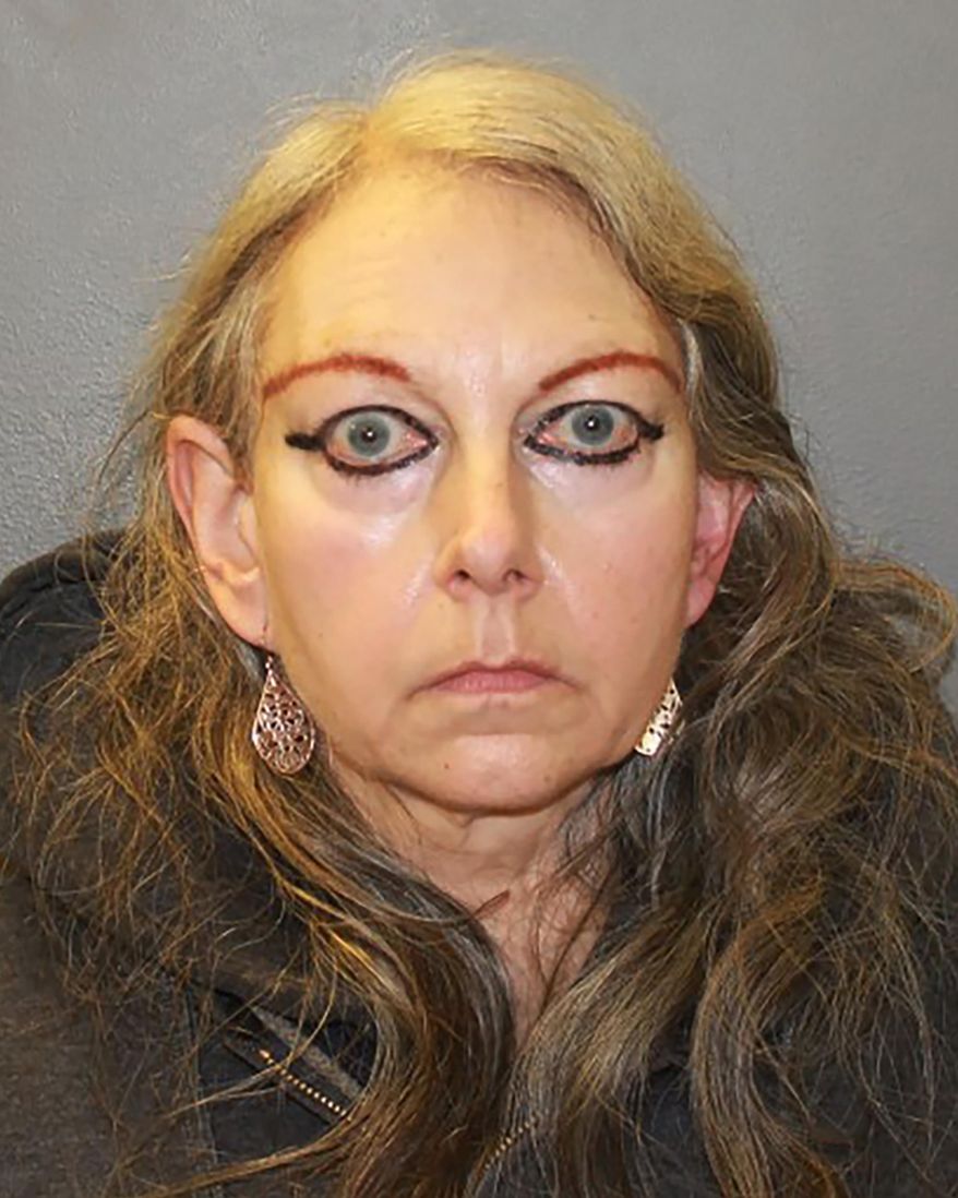 This photo provided by the Hamden, Conn., Police Department, shows Donna Scirocco, who turned herself in Tuesday, Dec. 15, 2020, because of an arrest warrant charging her with six counts of animal cruelty. Animal control officials from Hamden, several other towns and the state, executed a search warrant at Scirocco's home where they found 26 cats, six dogs, two caged squirrels a blind owl, two large rats, two dead cats and a dead woodchuck. She was detained on a $5,000 bond. (Hamden Police Department via AP)