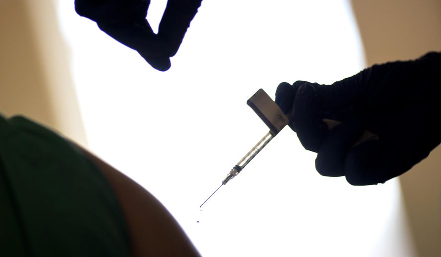 A droplet falls from a syringe after a health care worker was injected with the Pfizer-BioNTech COVID-19 vaccine at Women &amp;amp; Infants Hospital in Providence, R.I., Tuesday, Dec. 15, 2020. (AP Photo/David Goldman)
