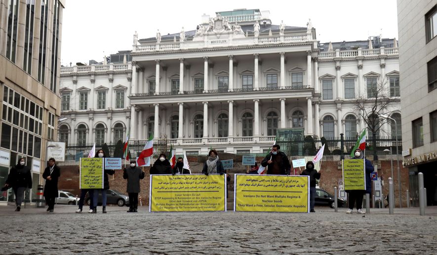 Members of the &#39;Council of Resistance of Iran&#39; demonstrate in Vienna, Austria, Wednesday, Dec. 16, 2020 for the reactivation of the sanctions resolutions of the UN Security Council against Iran. A bilateral meeting as part of the nuclear talks with Iran is taking place in Austria. (AP Photo/Ronald Zak)
