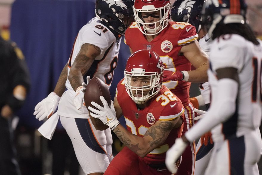 Kansas City Chiefs strong safety Tyrann Mathieu (32) intercepts a Denver Broncos quarterback Drew Lock pass in the first half of an NFL football game in Kansas City, Mo., Sunday, Dec. 6, 2020. (AP Photo/Charlie Riedel)