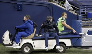 Seattle Seahawks tight end Greg Olsen (88) is taken off the field on a cart after going down with an injury against the Arizona Cardinals during the second half of an NFL football game, Thursday, Nov. 19, 2020, in Seattle. (AP Photo/Lindsey Wasson)