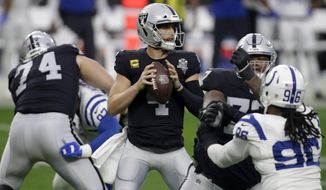 Las Vegas Raiders quarterback Derek Carr (4) looks to pass against the Indianapolis Colts during the first half of an NFL football game, Sunday, Dec. 13, 2020, in Las Vegas. (AP Photo/Isaac Brekken)