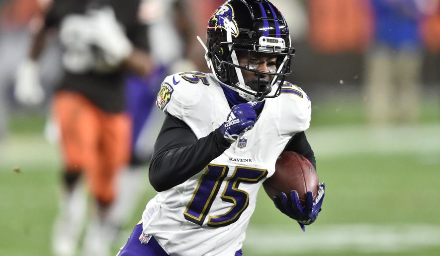 Baltimore Ravens wide receiver Marquise Brown (15) runs after catching a pass for a 44-yard touchdown during the second half of an NFL football game against the Cleveland Browns, Monday, Dec. 14, 2020, in Cleveland. The Ravens won 47-42. (AP Photo/David Richard)