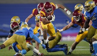 Southern California running back Vavae Malepeai, center, runs the ball during the fourth quarter of an NCAA college football game against UCLA, Saturday, Dec 12, 2020, in Pasadena, Calif. (AP Photo/Ashley Landis)